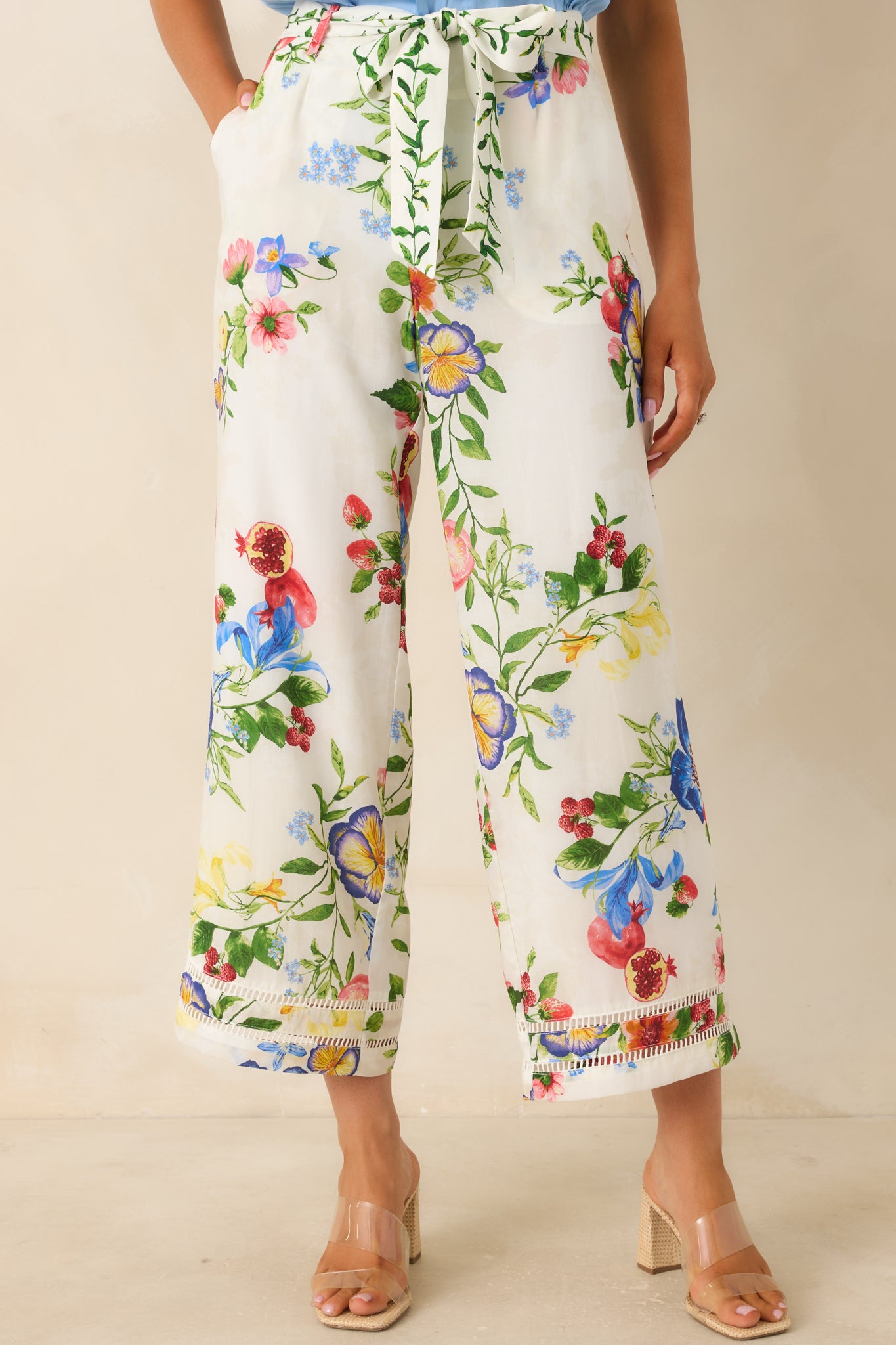 Hemline detail of cropped wide leg pants with delicate trim accent.