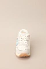 Front view of these sneakers that feature a rounded toe, functional laces, subtle pops of color, a slight platform, and a heavily textured sole.