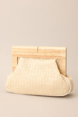 Front view of this ivory wood rattan clutch with a magnetic closure.