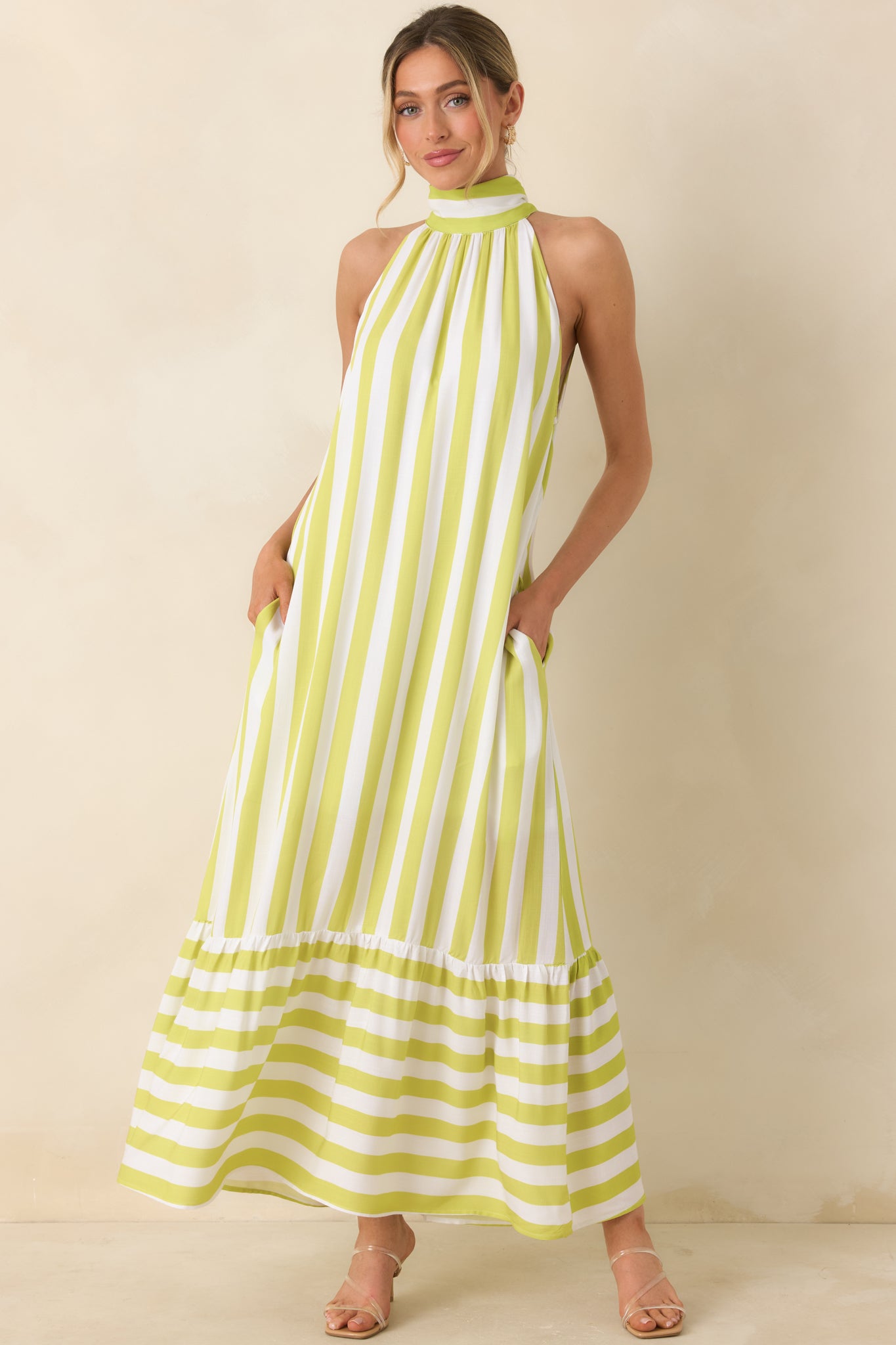 Chartreuse green and white striped halter dress, with relaxed silhouette and tiered hem.