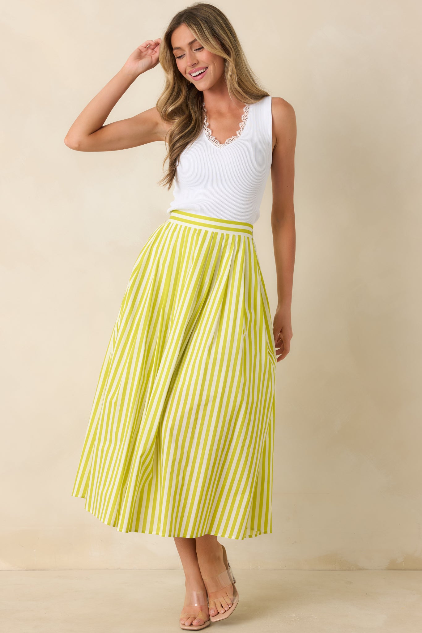 Fitted white ribbed tank top showcasing scalloped lace trim along the V-neck and a clean, streamlined silhouette.