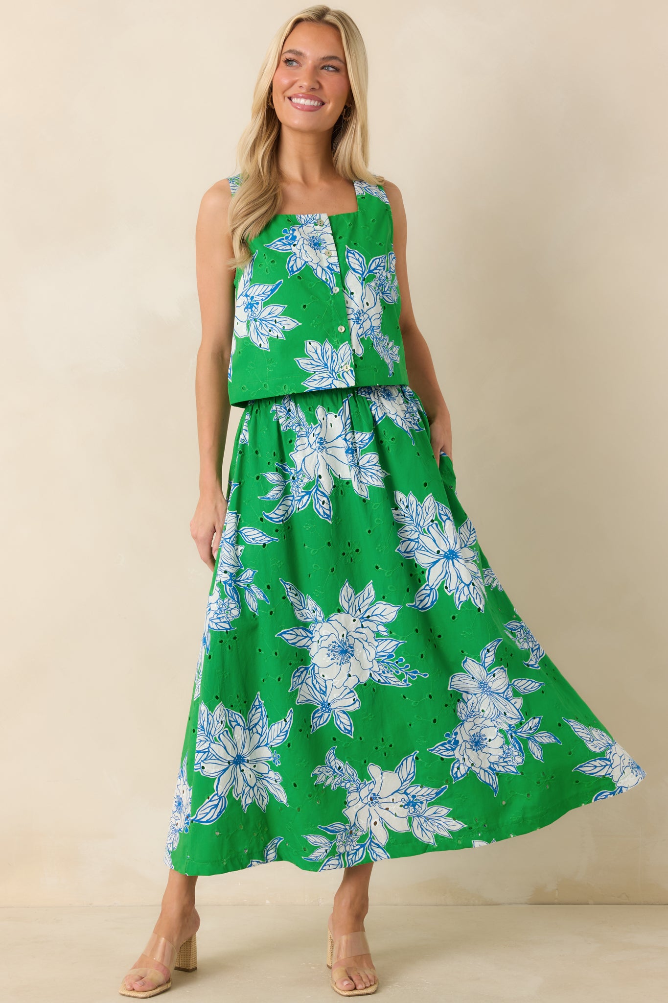 Floral print crop top with a button-front closure, square neckline, and fresh eyelet texture creating a light, summery feel.