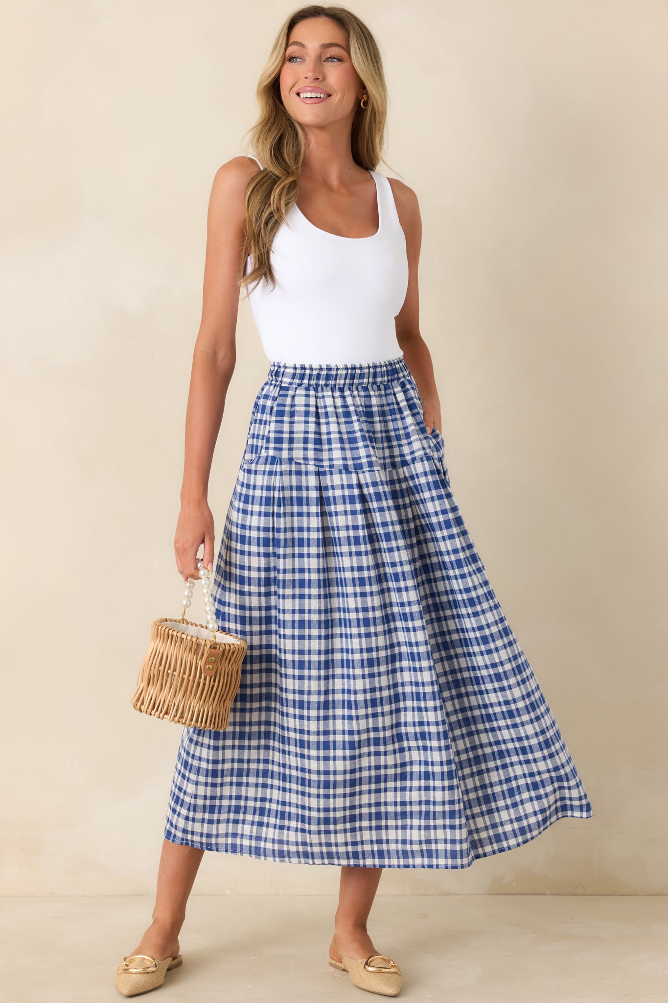 Blue and white gingham midi skirt with flowy silhouette and elastic waist.