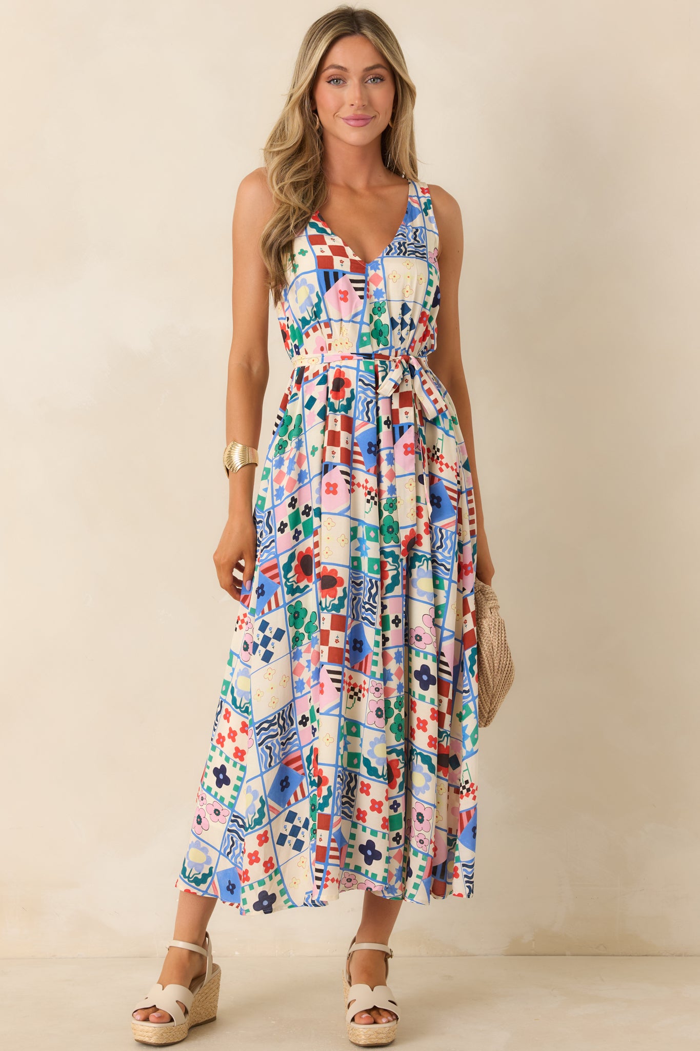 Sleeveless midi dress with plunging V-neckline and tile-inspired patchwork print.

