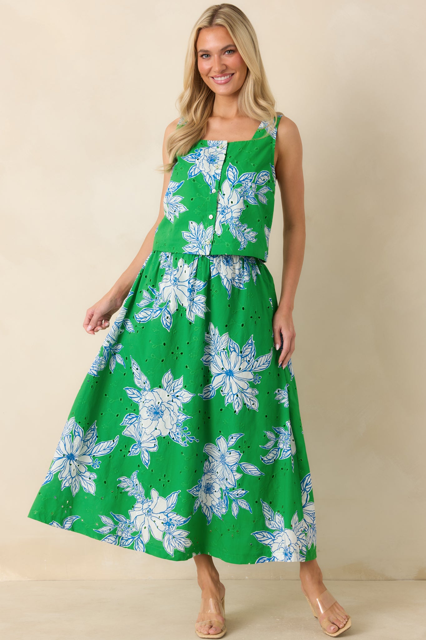 Green and white floral eyelet crop top with a structured cropped silhouette, square neckline, and sleeveless design in lightweight cotton.