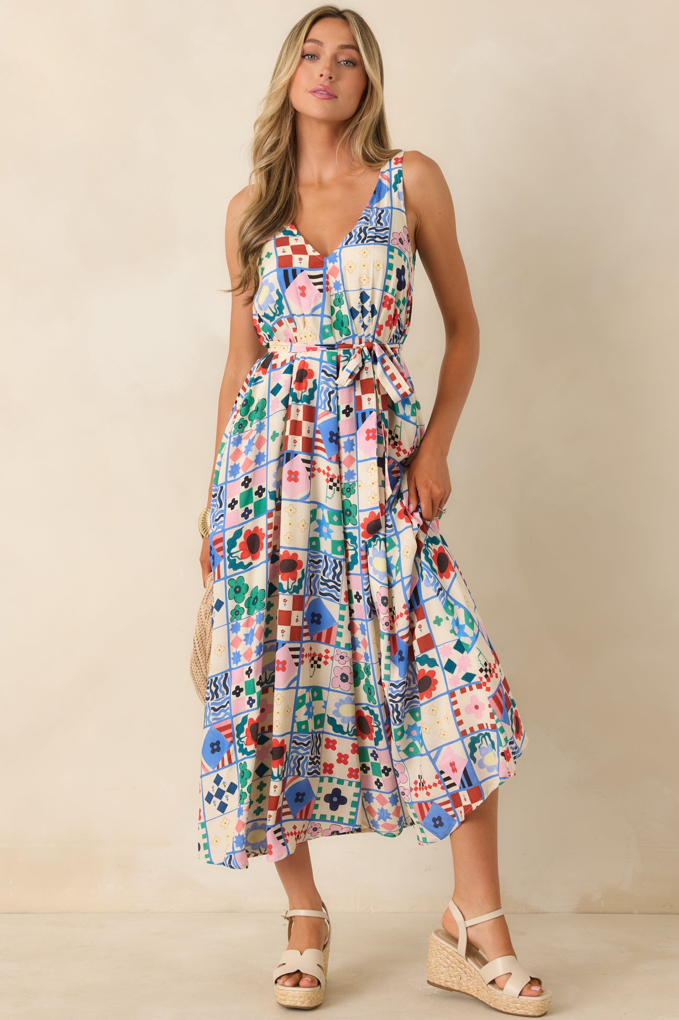 Flowy patchwork print midi dress with softly gathered waist and self-tie belt.
