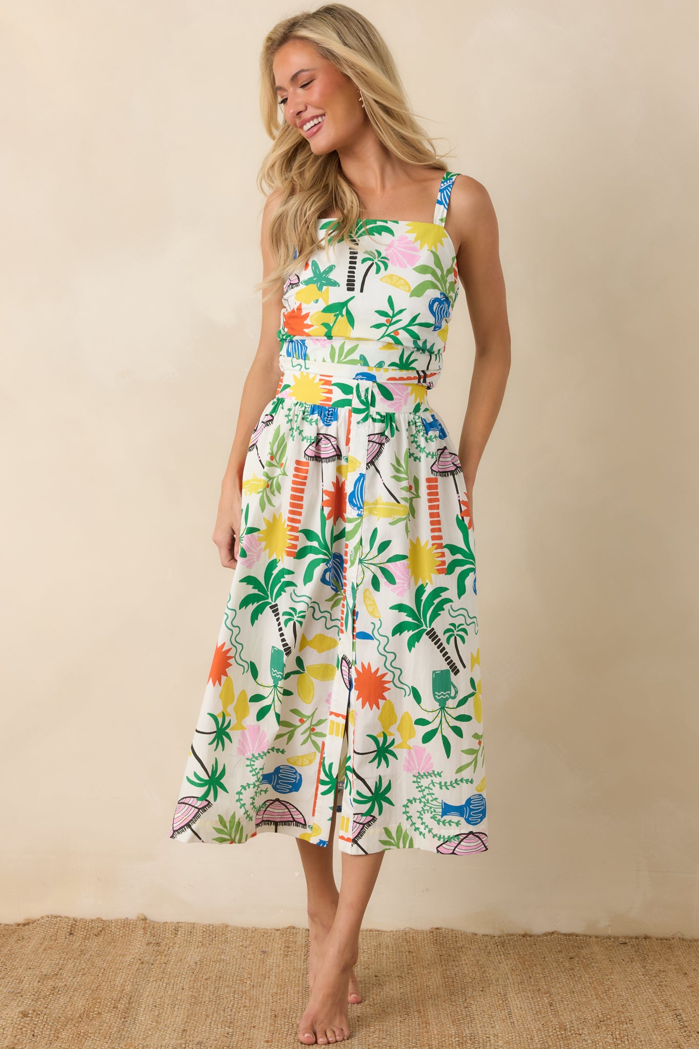 Lightweight printed top showcasing a cropped silhouette, structured straight neckline, and bold coastal motifs.