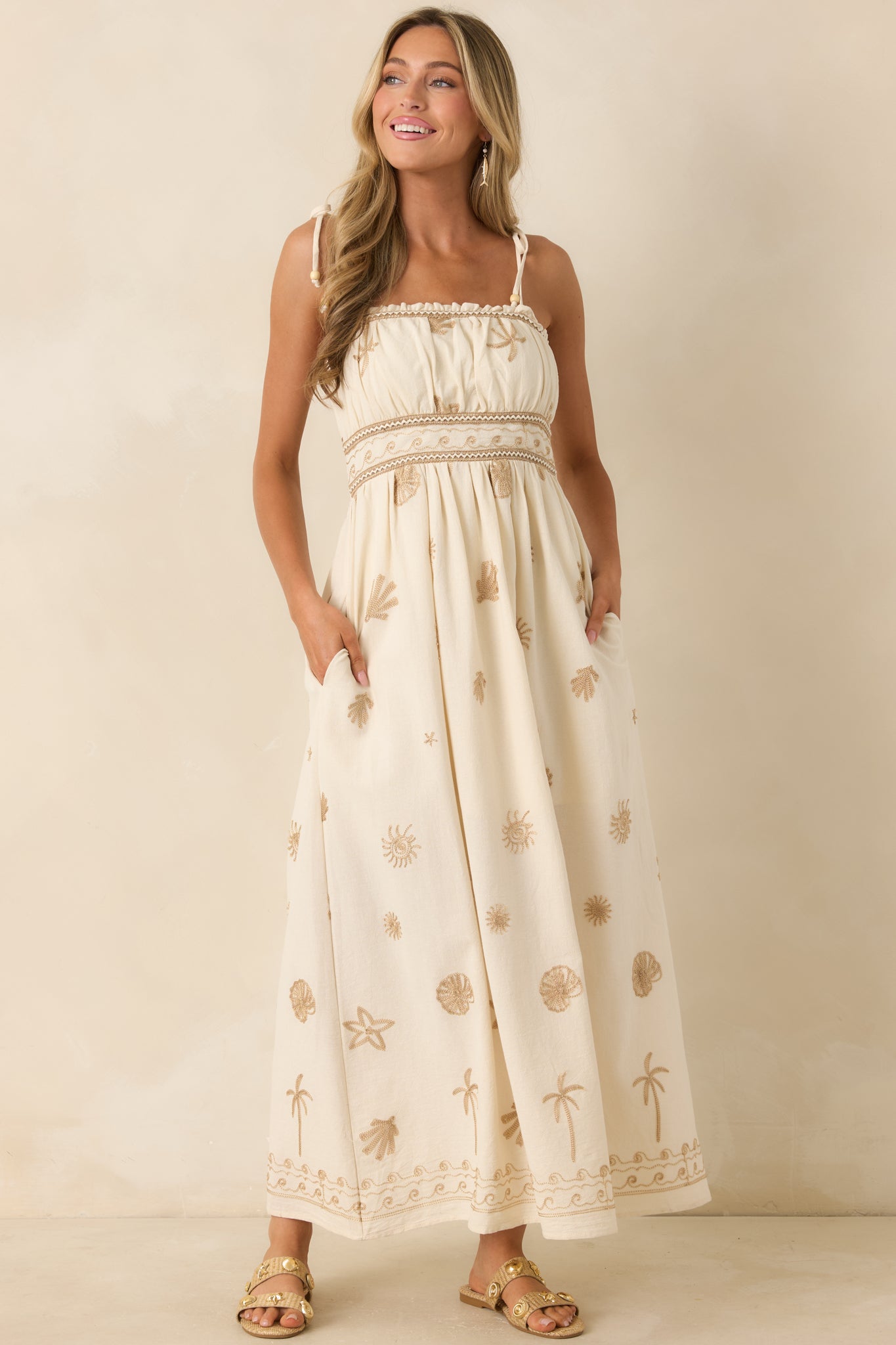 Lightweight ivory dress with a smocked elastic back panel and relaxed maxi-length silhouette.