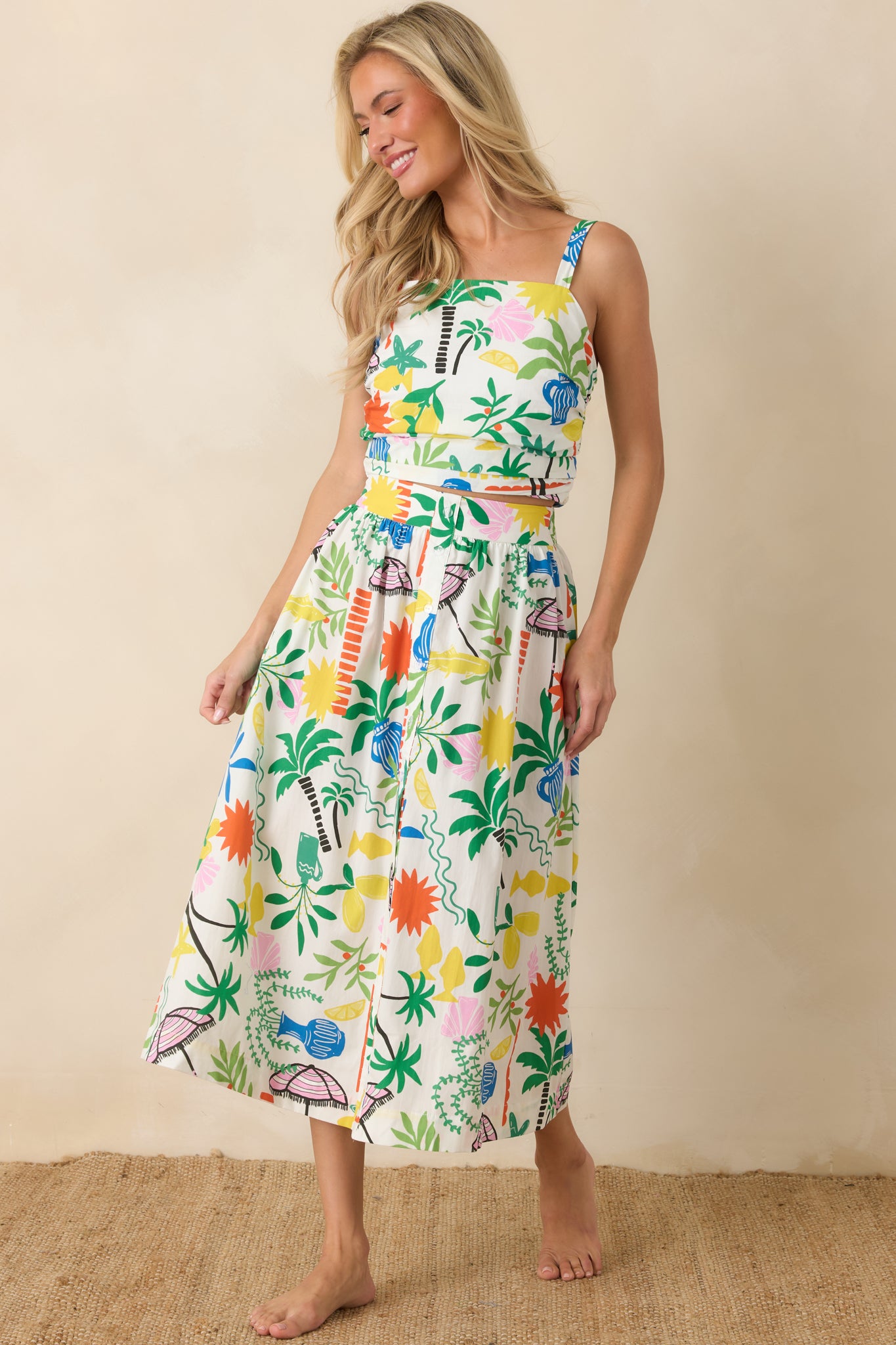 White multi midi skirt featuring a high-rise waistband, flowing A-line silhouette, and vibrant coastal resort print.