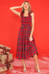 Full body view of this dress that features thick ruffle straps, smocked bodice, and a tiered skirt. 