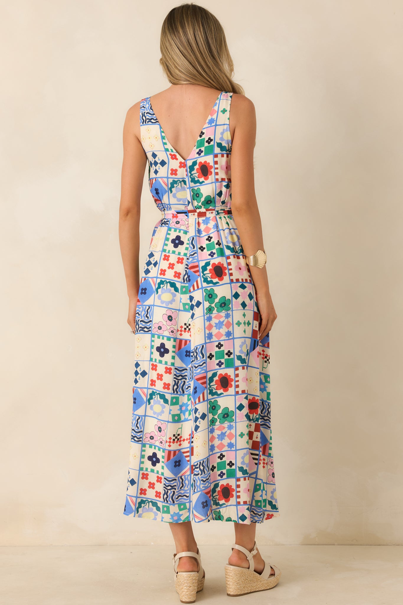 Rear view of midi dress with low V-back and softly flowing skirt shape.