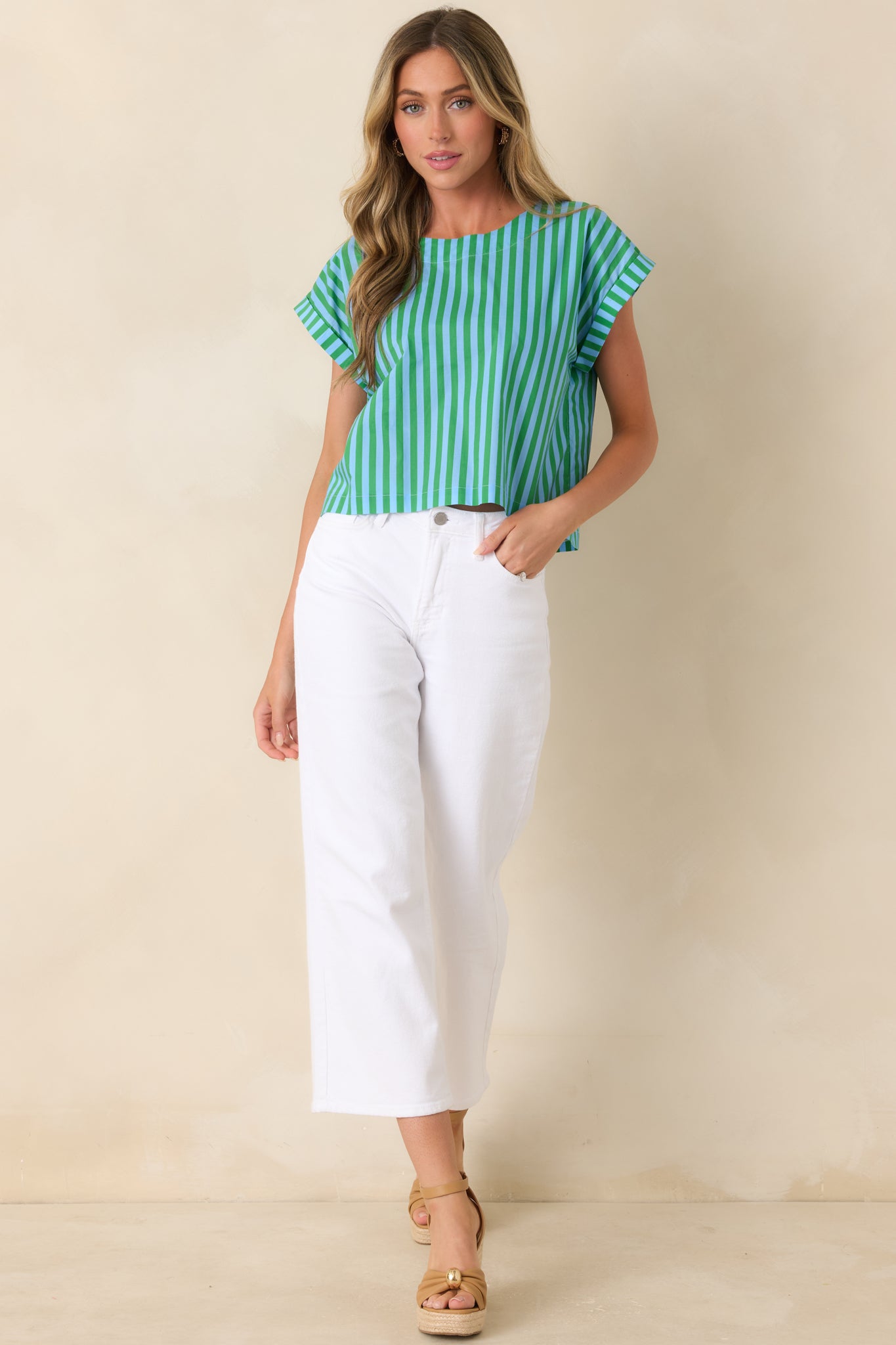 Boxy cotton top with blue and green vertical stripes, round neckline, and cuffed short sleeves.