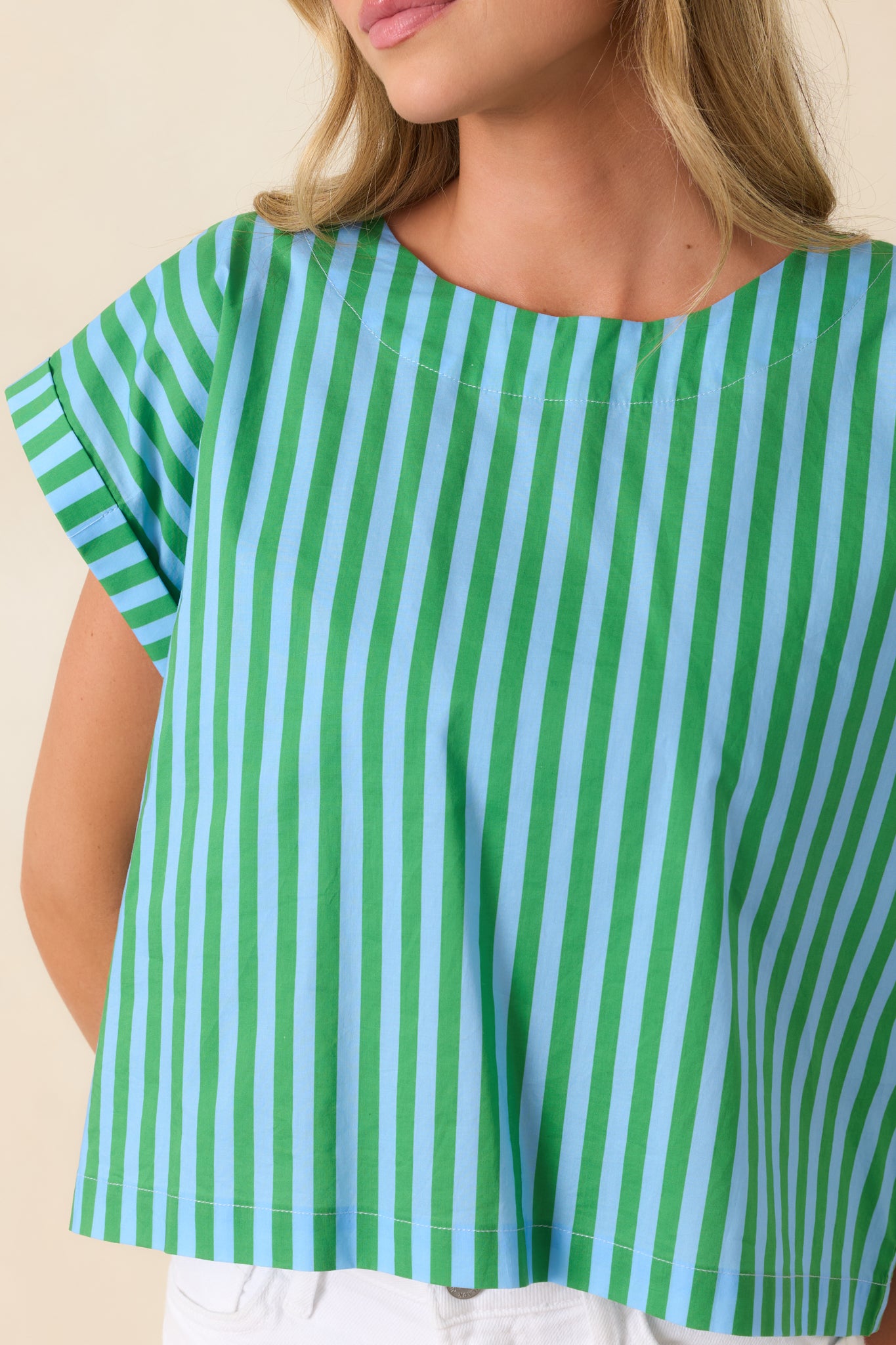 Detailed look at blue and green stripe fabric with structured stitching and clean edges.