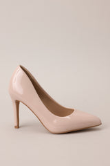 Side view of these beige heels with a pointed toe, vibrant color, glossy finish, and skinny heel.