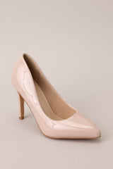Angled side view of these Beige heels with a pointed toe, vibrant color, glossy finish, and skinny heel.