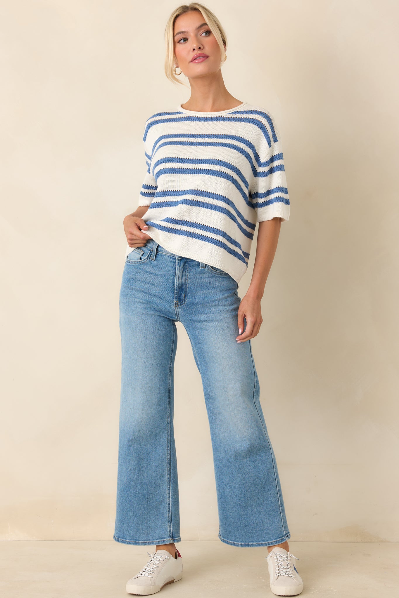 Relaxed fit sweater top with blue stripes, short sleeves, and airy feel.