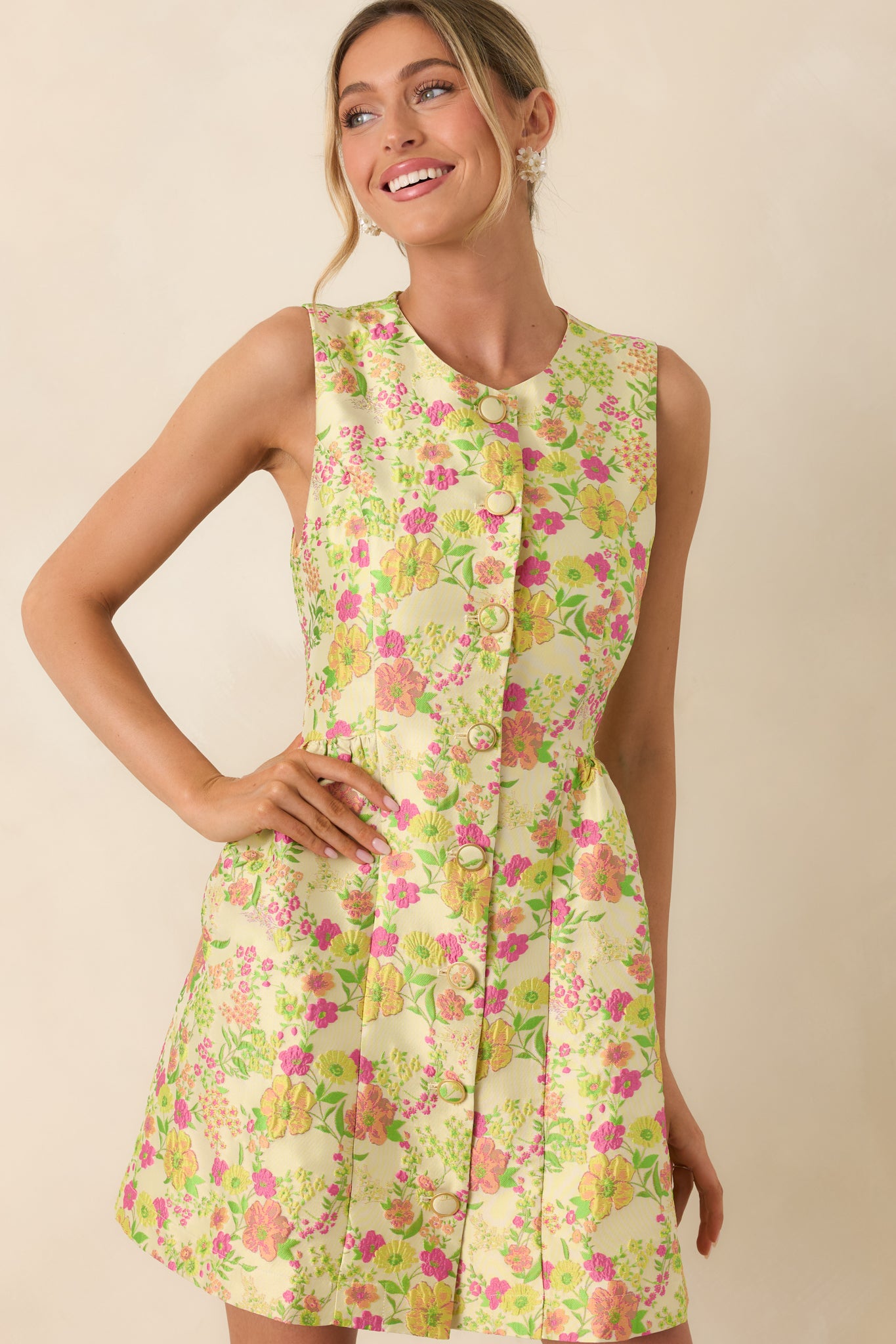 Mid-section close-up of floral mini dress showing button-front detail and subtle waist shaping.