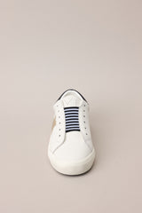 Front view of these sneakers that feature a rounded toe, a laceless design, a comfortable fit, and a star detail.