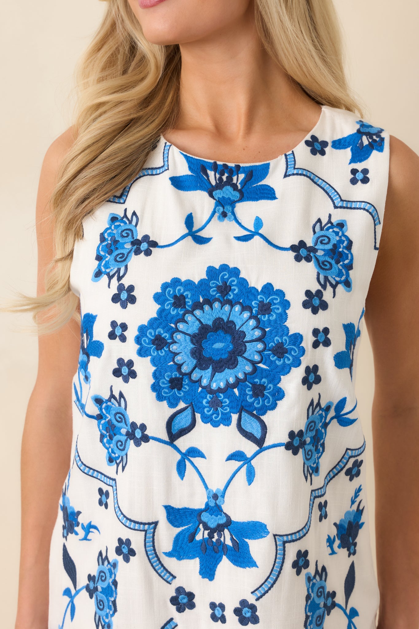 Close-up of intricate mosaic floral embroidery with textured stitching.