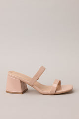 Side view of these tan block heels that feature a square toe, two nude straps across the top of the foot, and a block heel.