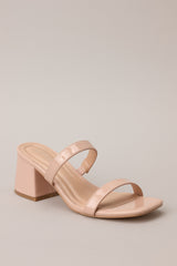 Angled side view of these tan block heels that feature feature a square toe, two nude straps across the top of the foot, and a block heel.