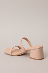 Back view of these nude block heels that feature a square toe, two nude straps across the top of the foot, and a block heel.