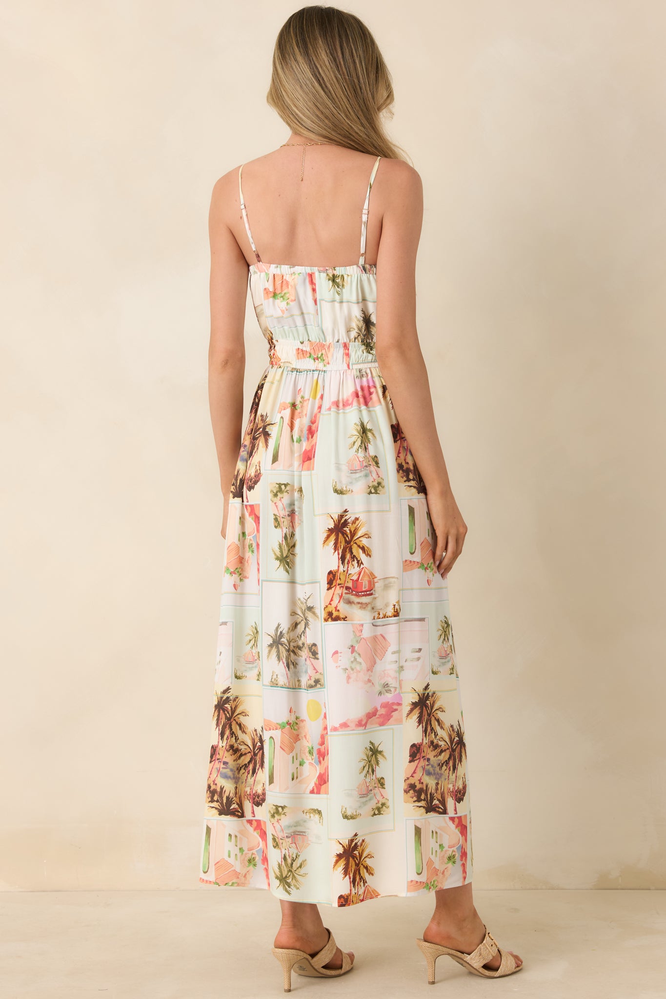 Back view of the Dolce midi sundress highlighting the adjustable straps, gathered waist, and flowing fabric in the multi postcard print.