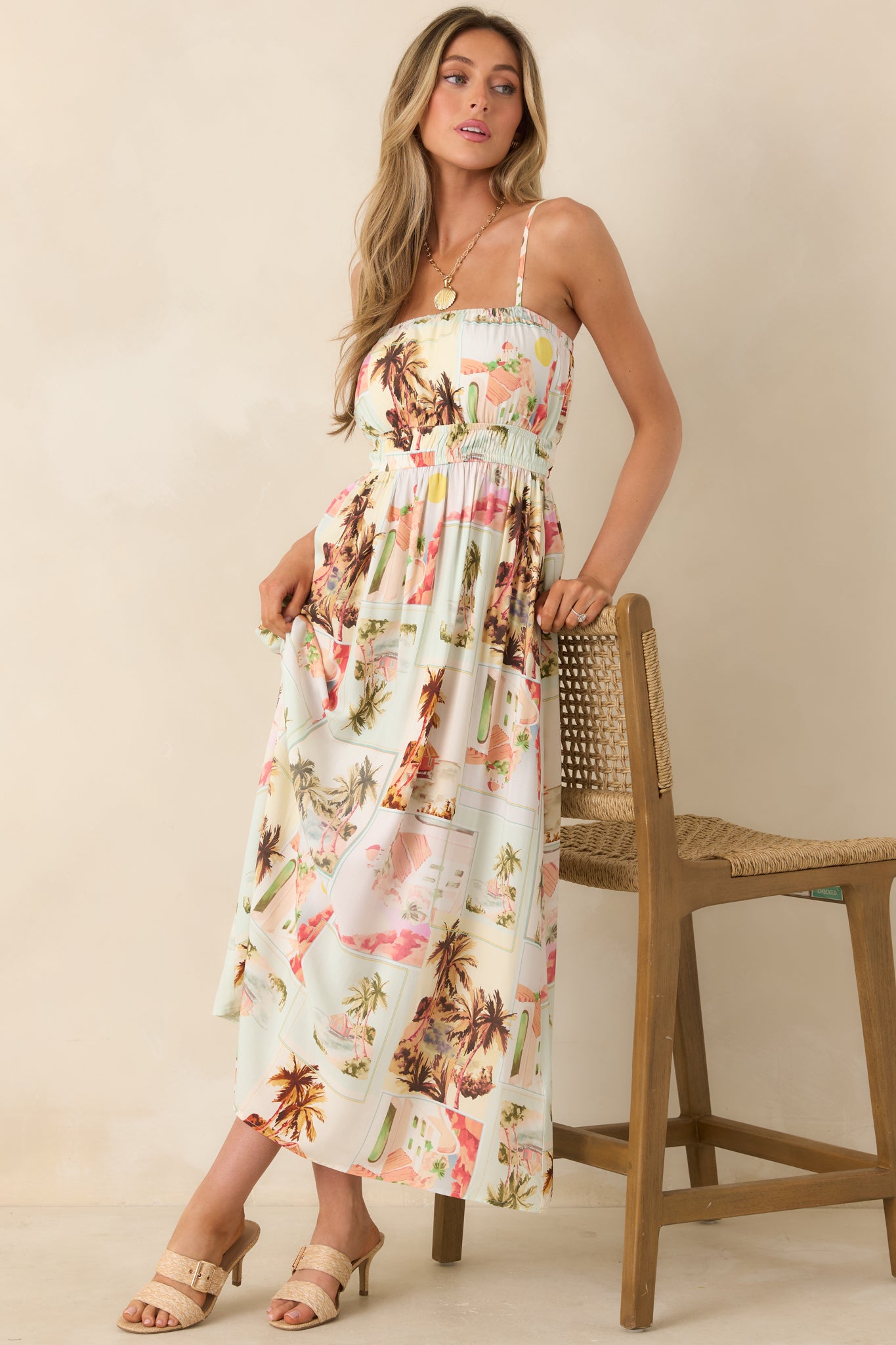 Vintage postcard-inspired midi sundress with a softly gathered waist, breathable fabric, and sun-washed hues.