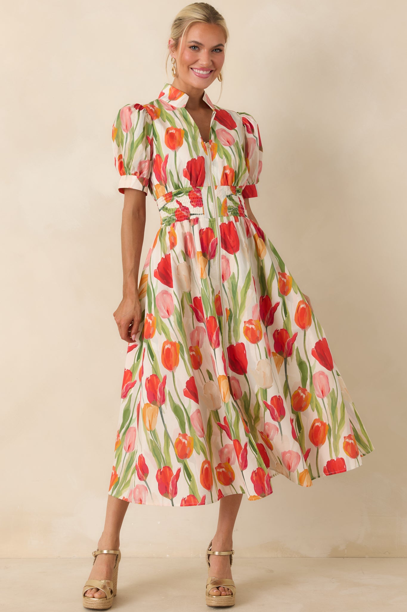 Ivory cotton midi dress with vibrant red and multi-color tulip print, zip front, and smocked waist.