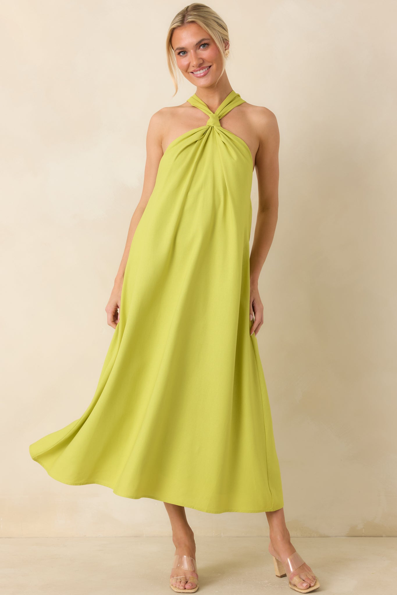 Chartreuse linen blend midi dress featuring a draped halter neckline, twisted front detail, and relaxed flowy silhouette.