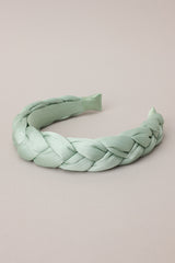Flat top view of this headband featuring a thick, soft material, and a braided texture.