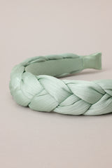 Close up view of this headband featuring a thick, soft material, and a braided texture.