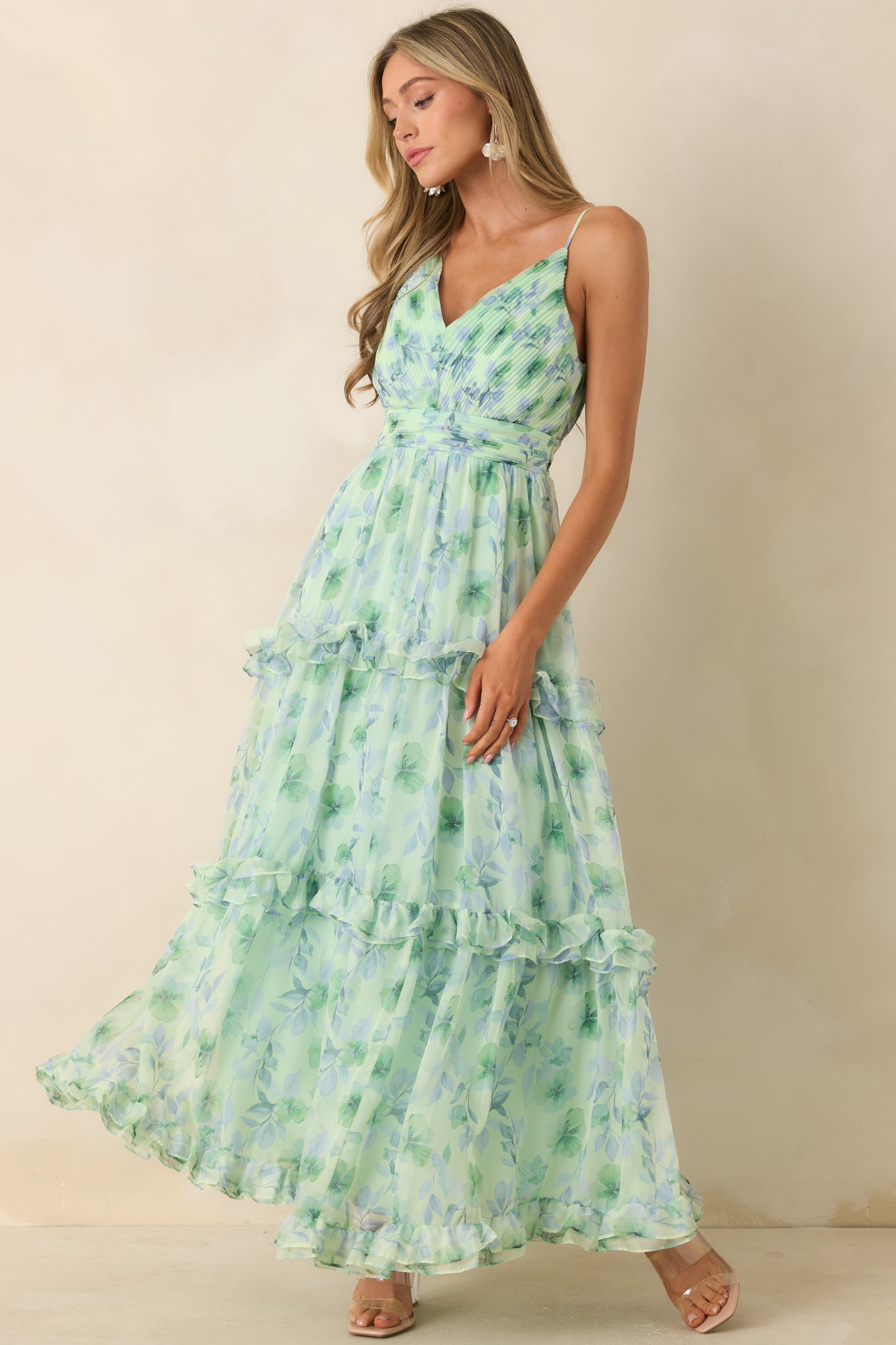 Flowing maxi dress showcasing an empire waistline and tiered ruffle detailing in a lightweight chiffon fabric.