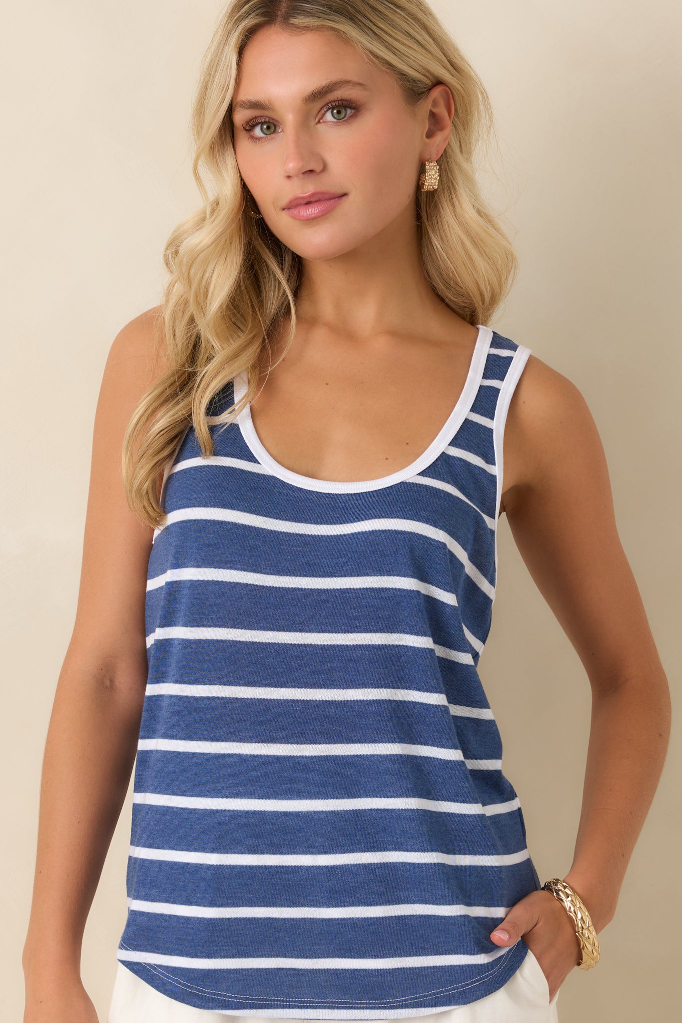Cropped view focusing on the sleeveless arm openings and neat finishing details along the edges.