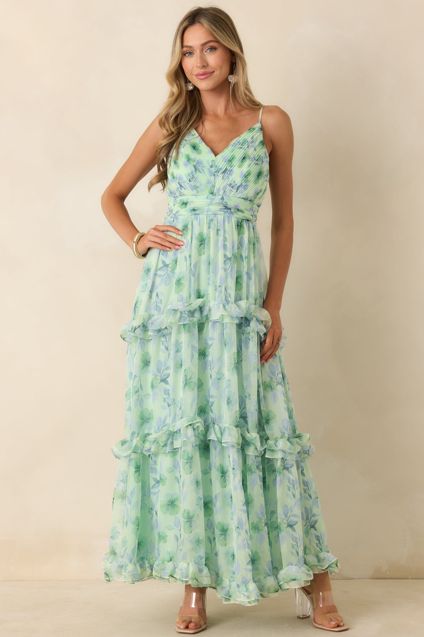 Green chiffon maxi dress with a flattering empire waist and airy tiered construction for added movement.