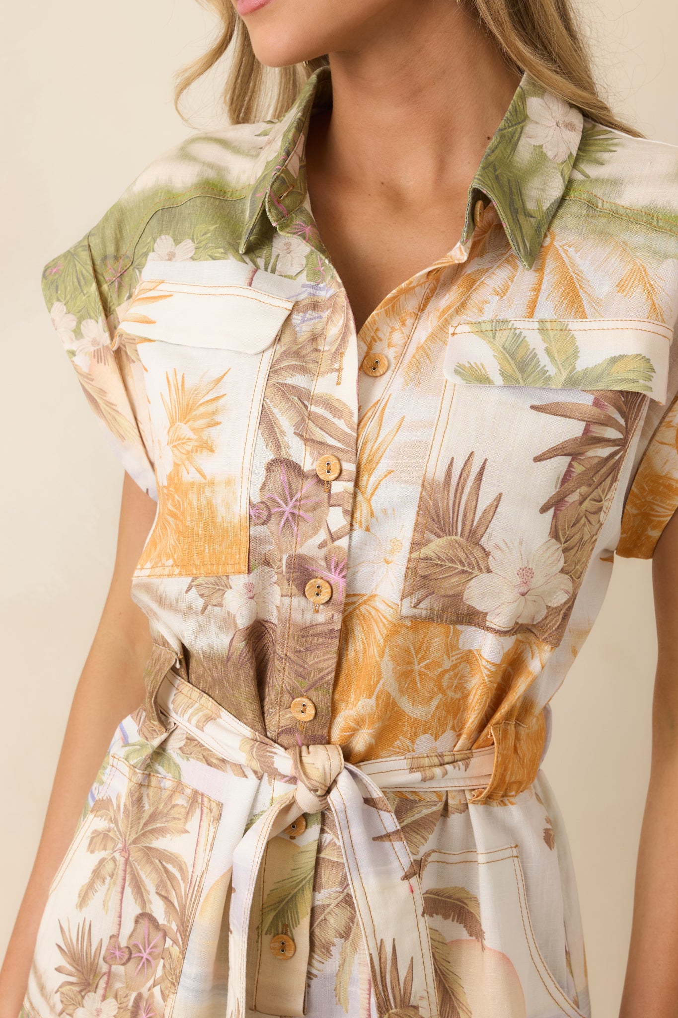 Close-up of tropical print fabric with multi-colored palm and landscape accents.