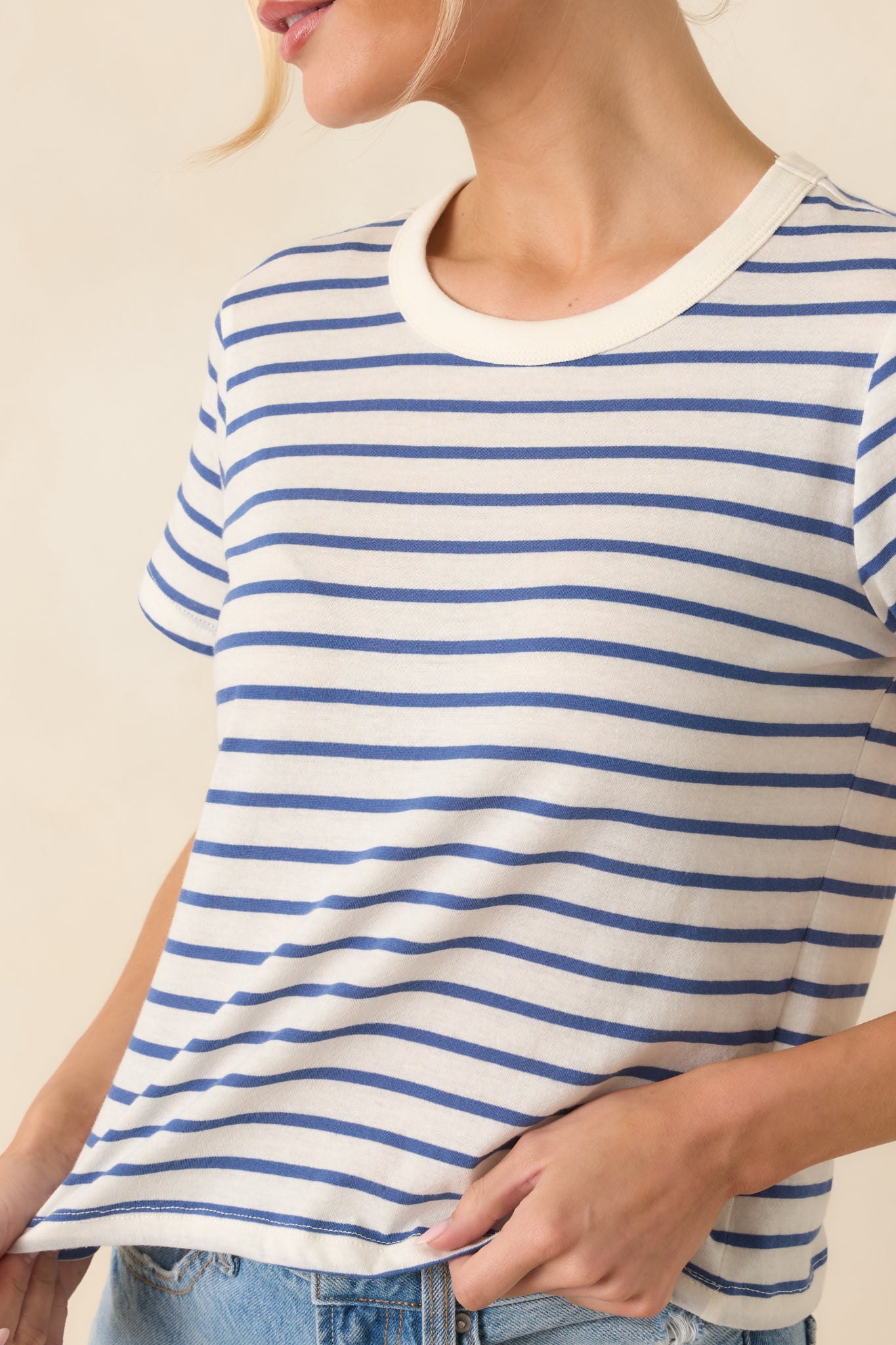 Close-up of the fabric showing the deep blue and white stripe pattern with soft woven cotton texture.