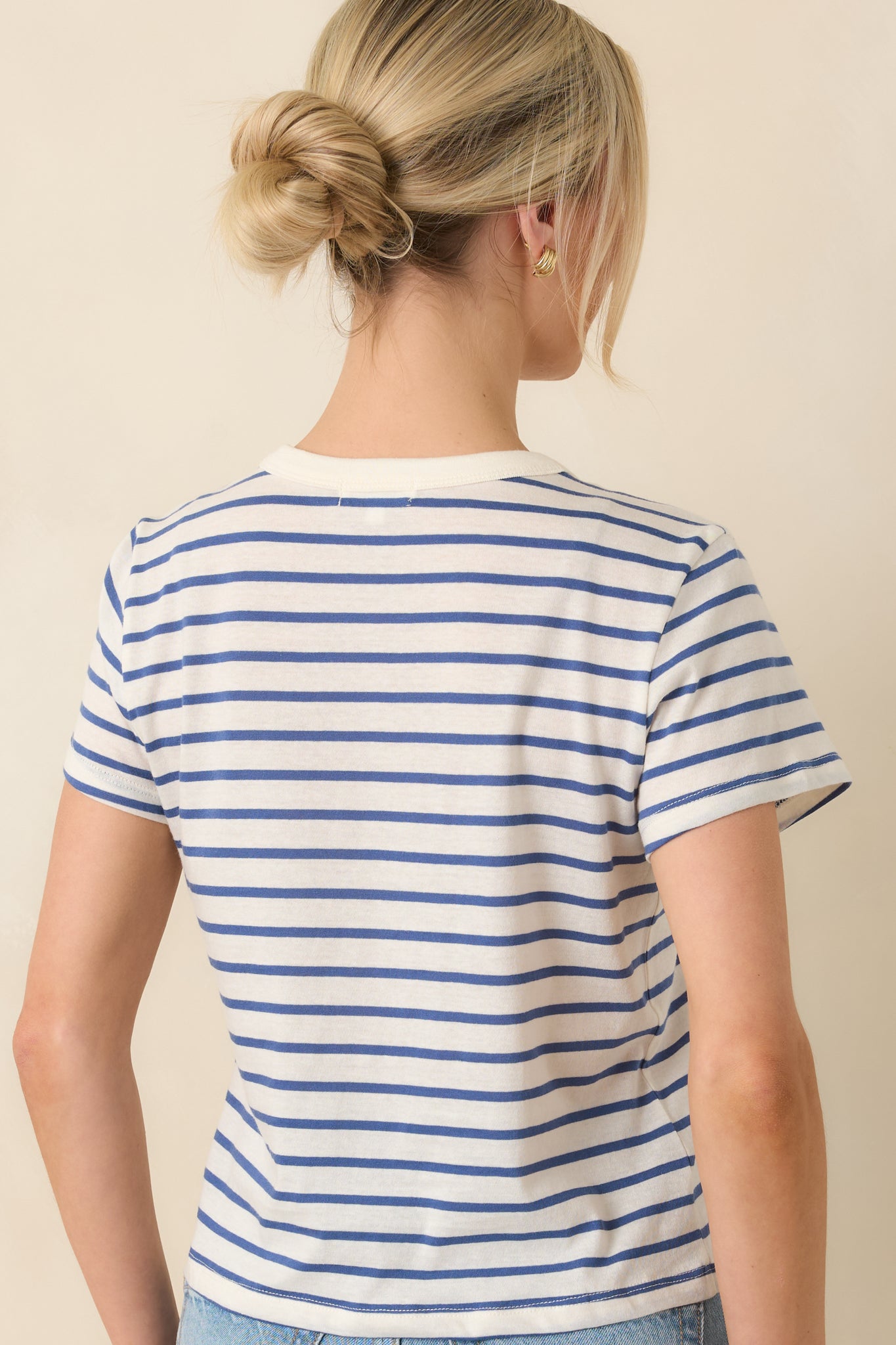 Rear view of the striped tee featuring a clean crew neckline finish and continuous blue and white stripe pattern across the relaxed silhouette.

