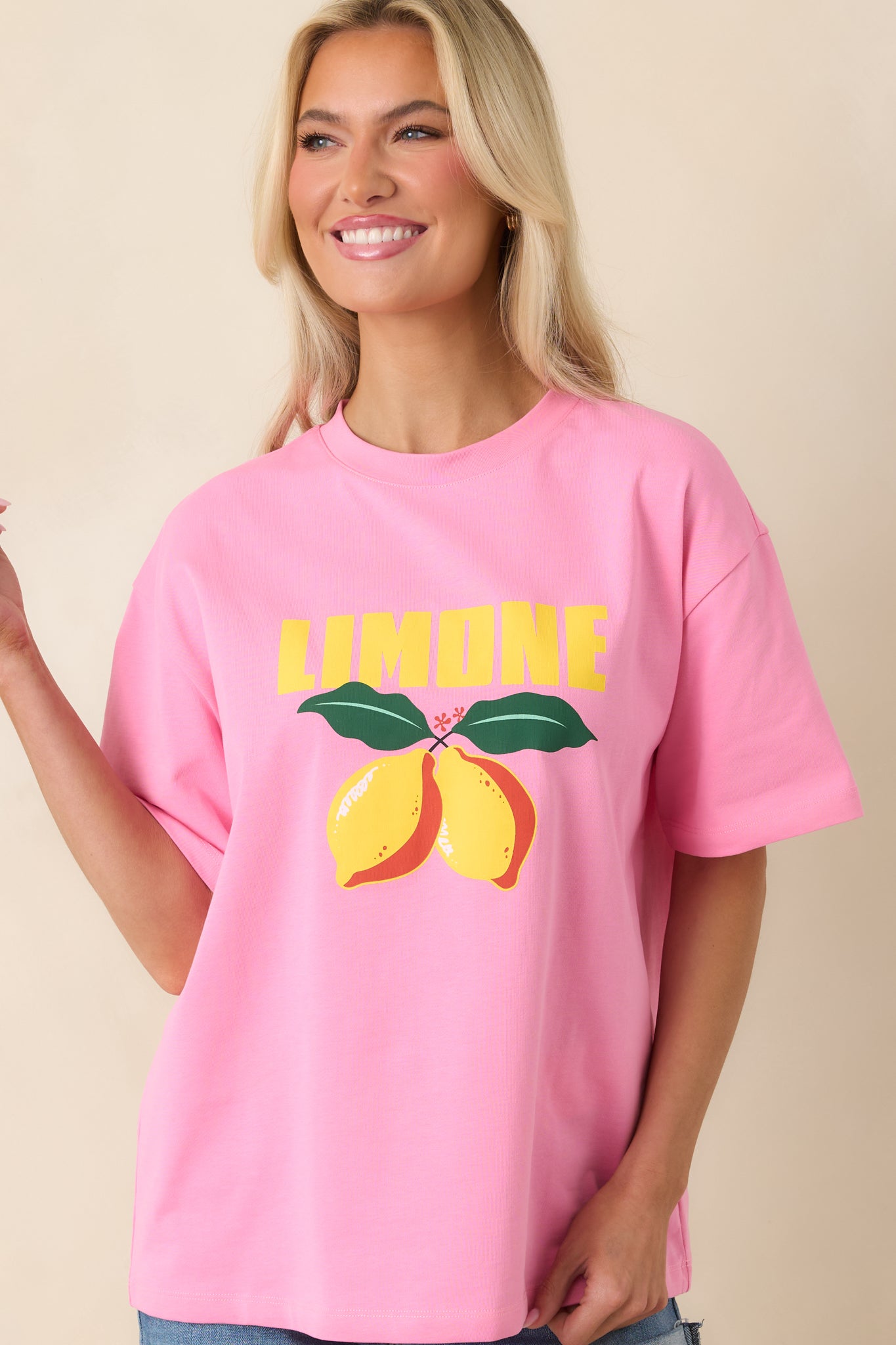 Pink tee close-up with soft fabric texture and playful printed motif.
