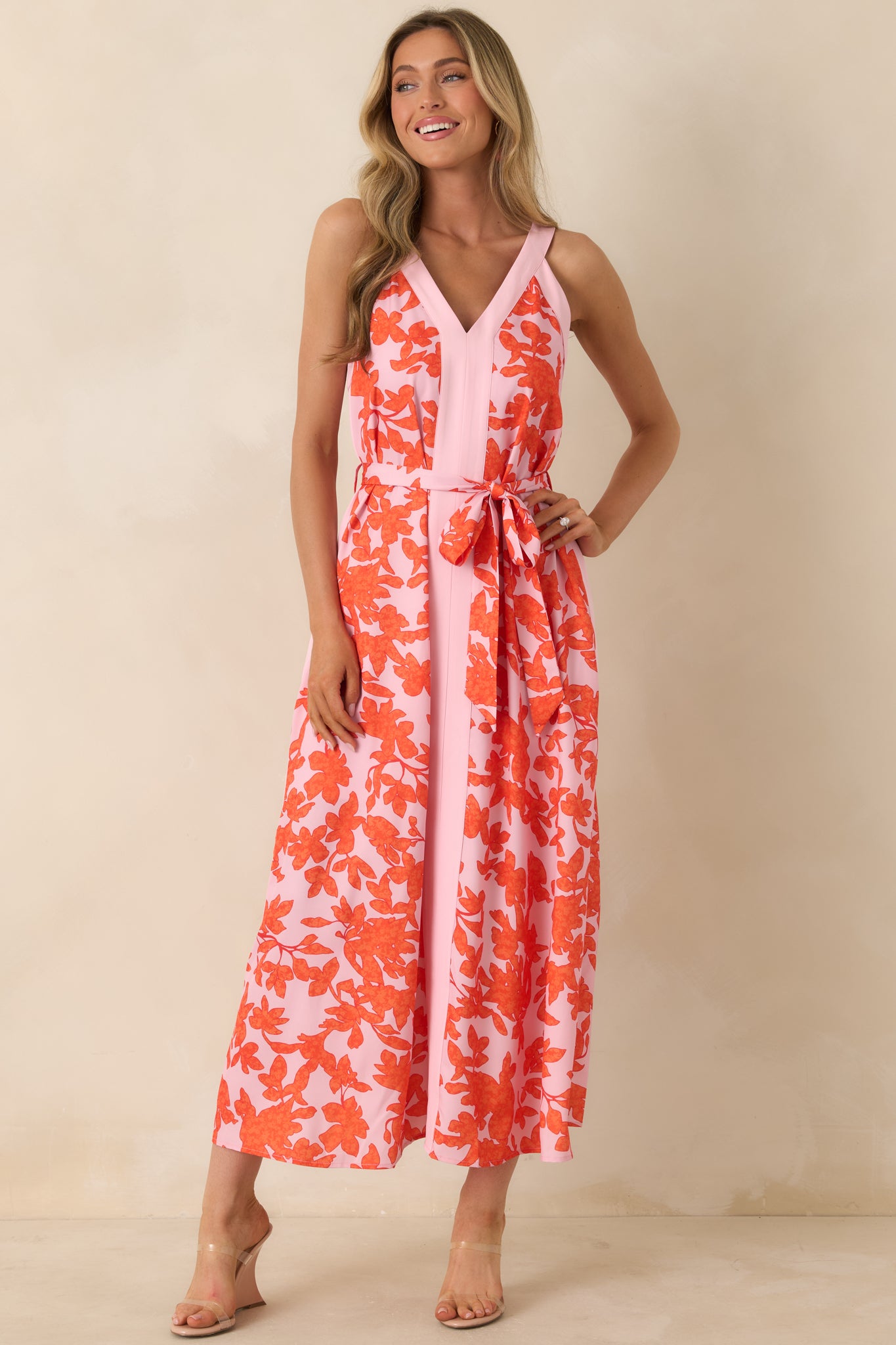 Pink and orange floral dress with cinched waist and flowing skirt for effortless movement.