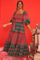 Full body view of this dress that showcases the red and green alternating patterns down the dress.