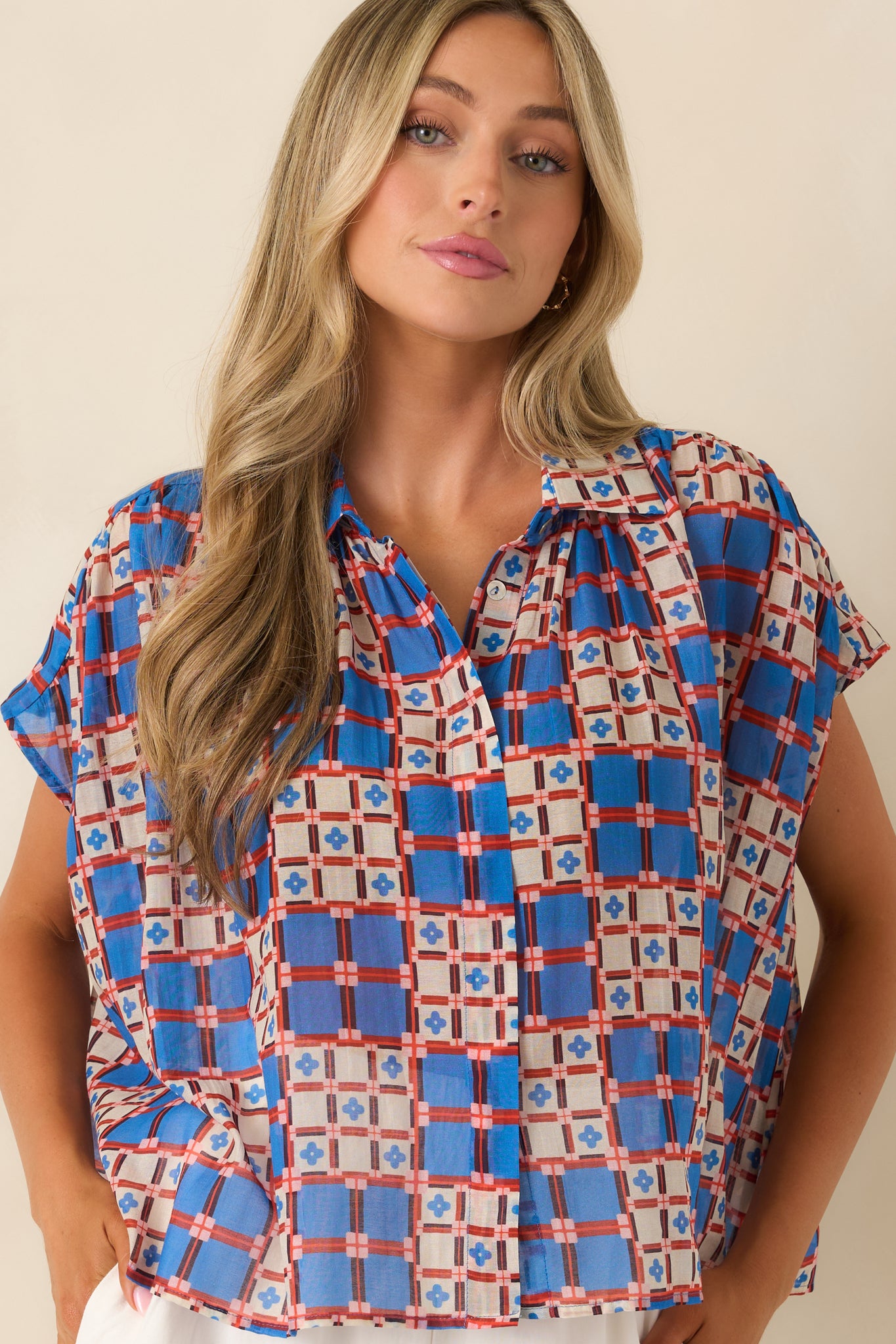 Button-front placket with airy, semi-sheer fabric and refined structure.