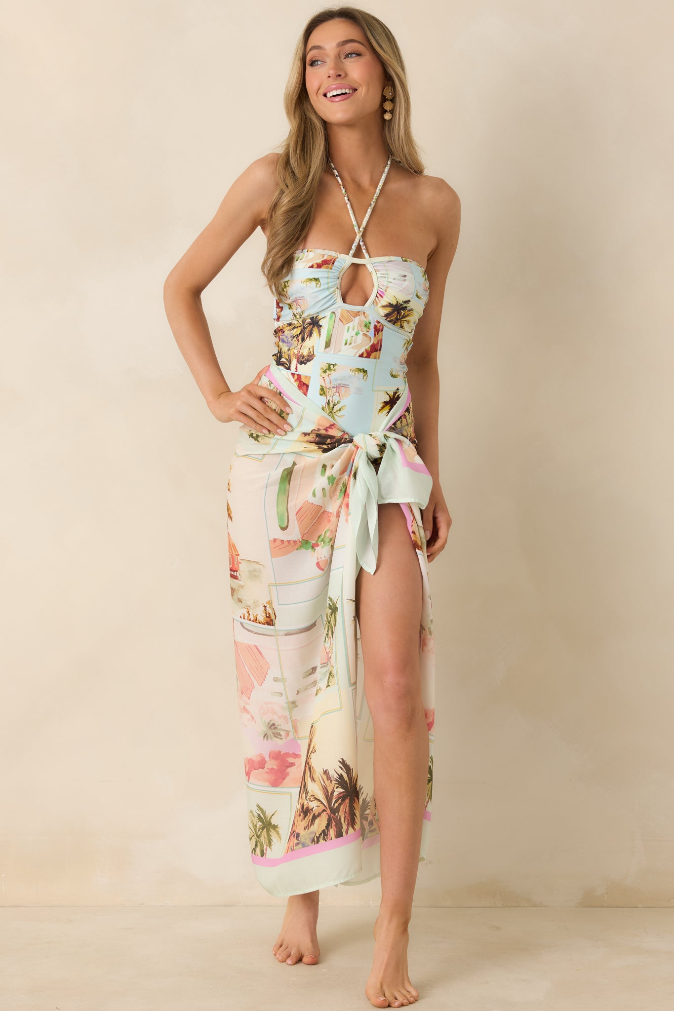 Lightweight wrap sarong featuring colorful scenic postcard collage print and adjustable tie at the waist