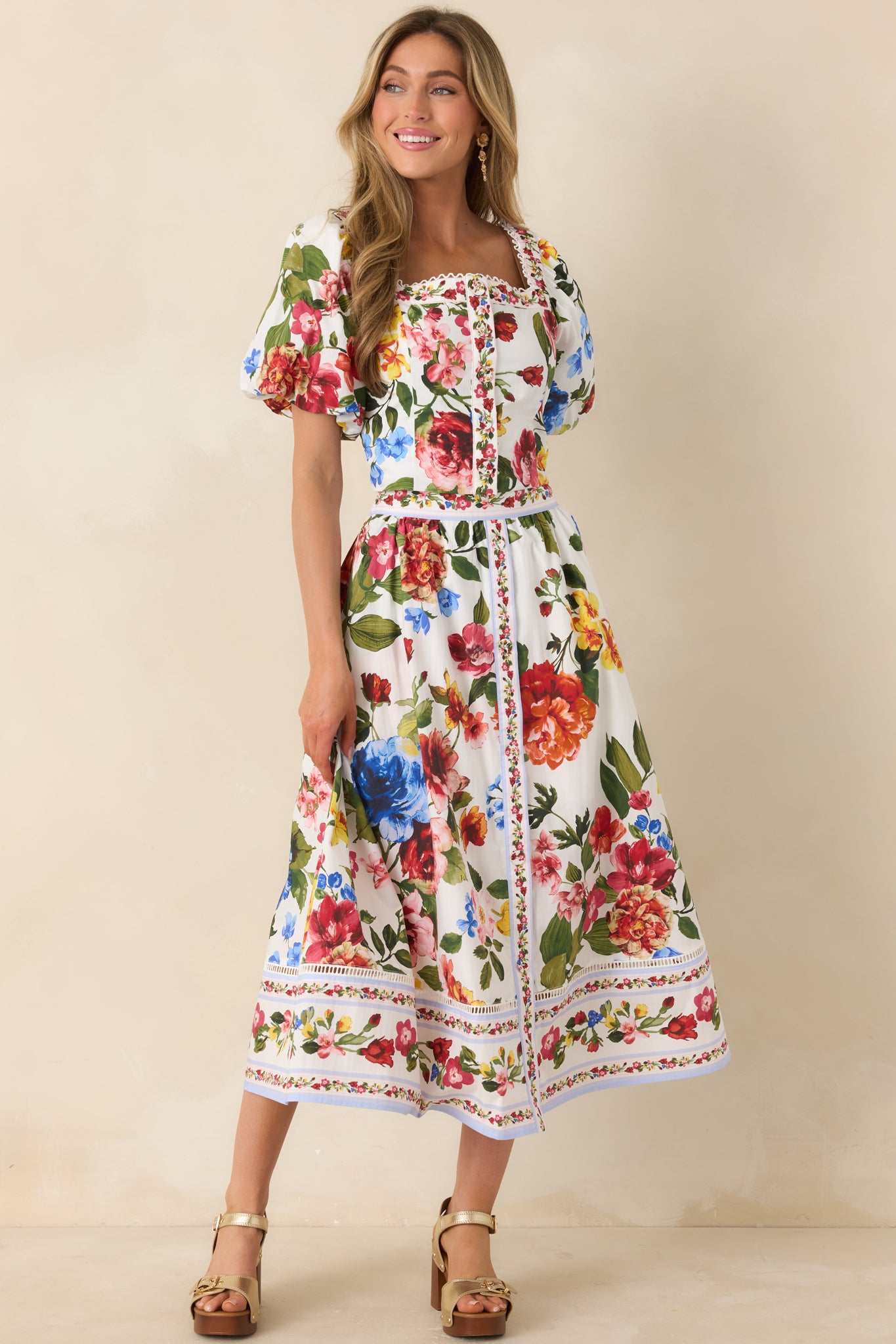 Multi-floral ivory top featuring intricate border accents and fitted shape.