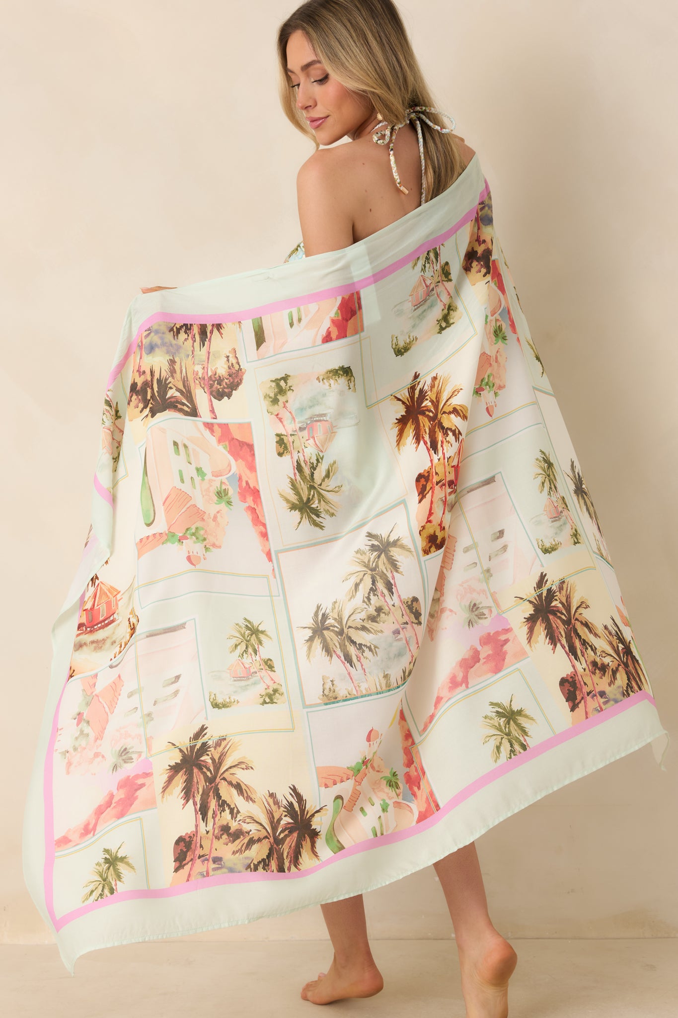 Multi vintage postcard print sarong with wrap-style silhouette, side tie closure, and flowy midi length