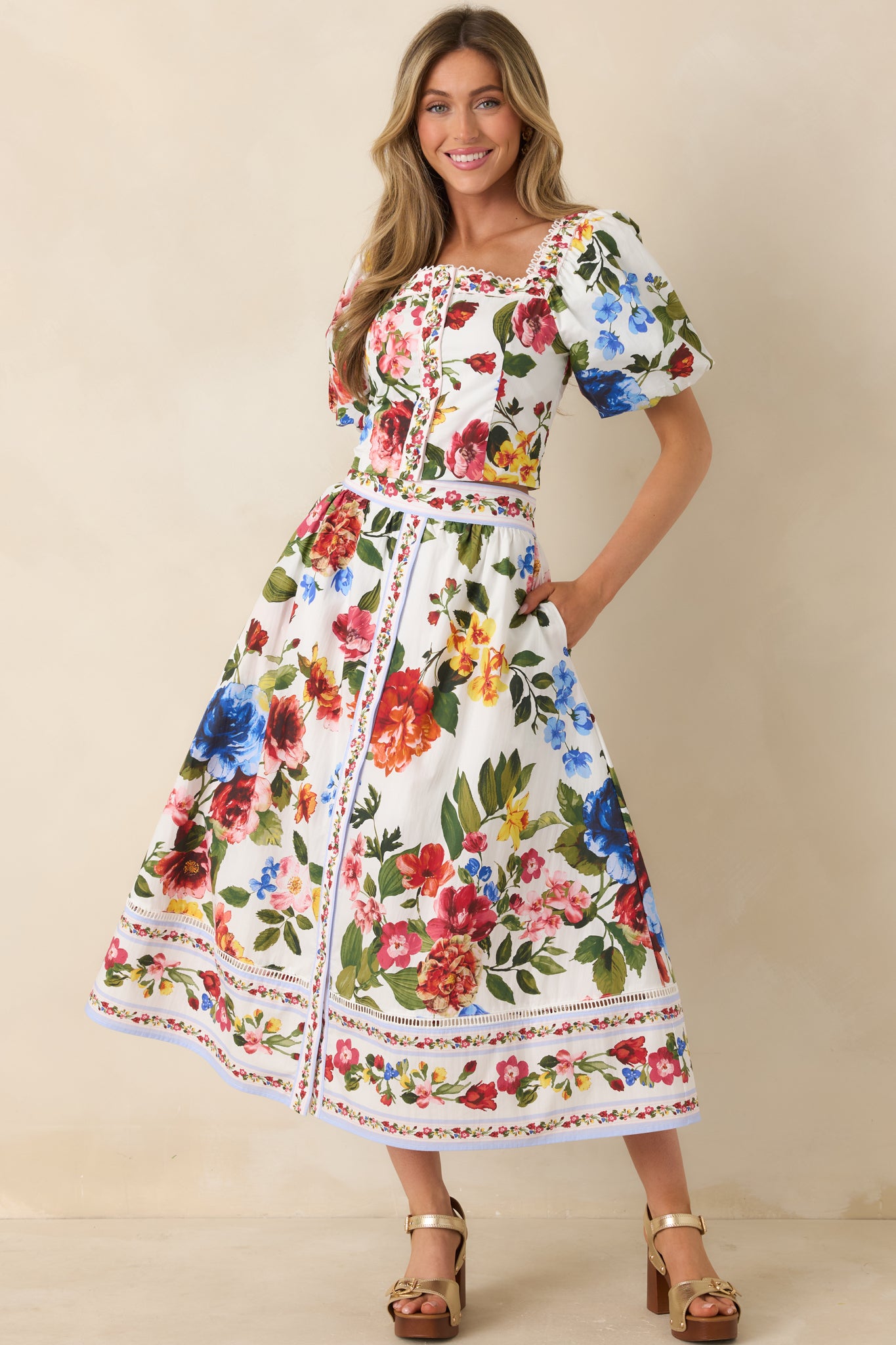 Ivory top with vibrant multi-floral print and tailored bodice.