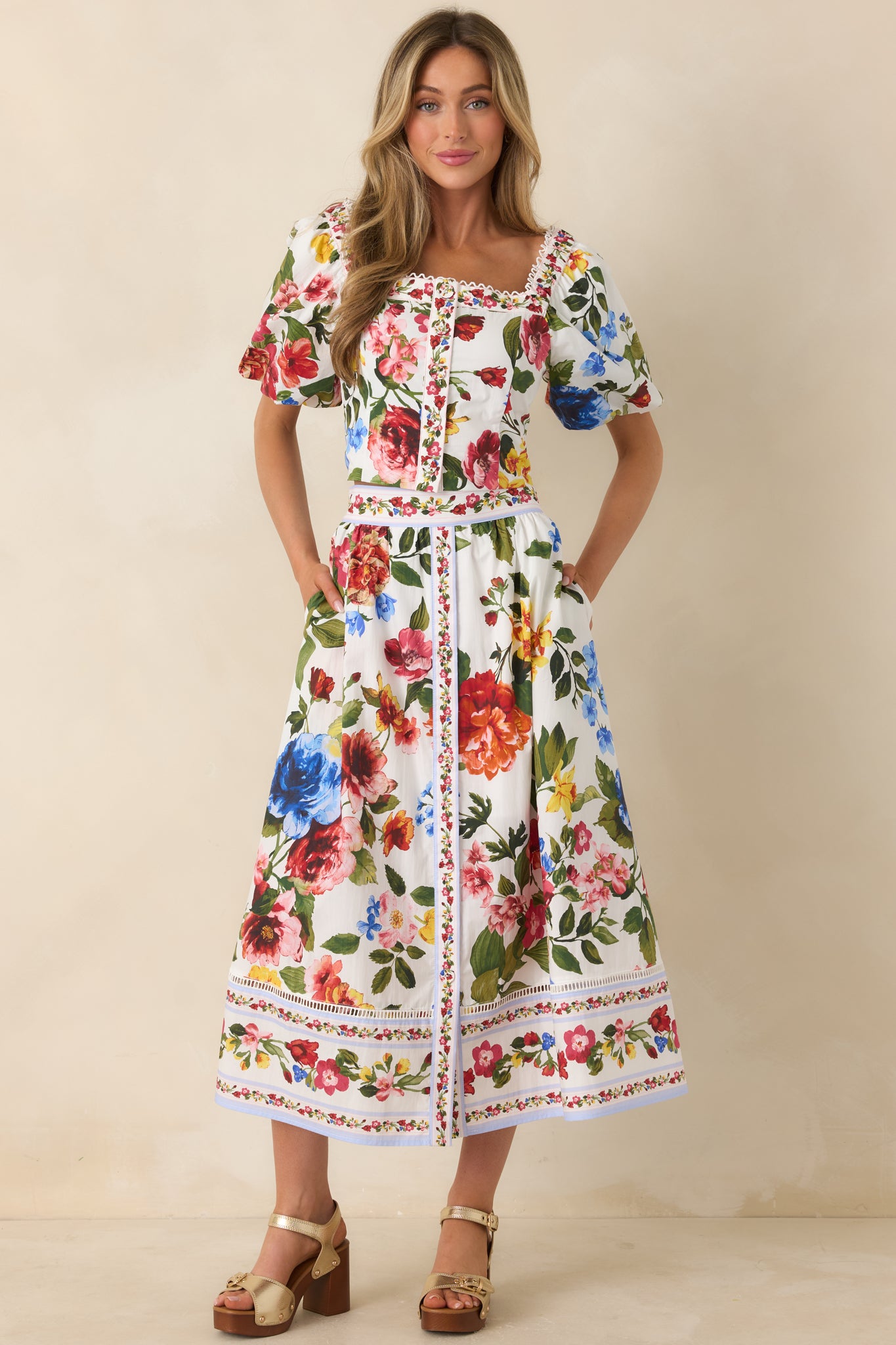 Flowing ivory floral skirt with border detailing along hemline.