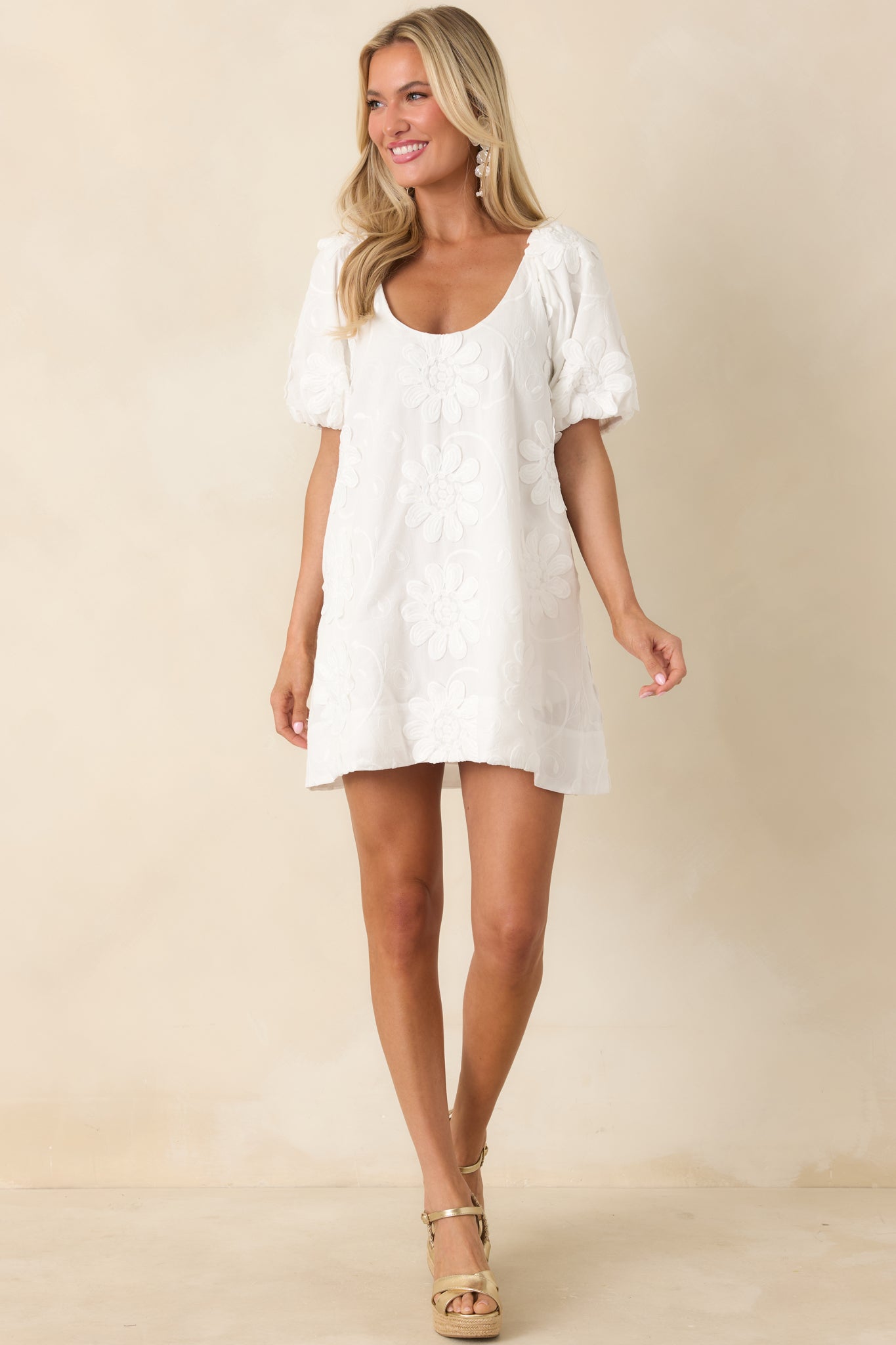 Straight front view highlighting puff sleeves, relaxed fit, and delicate floral appliqué detailing.