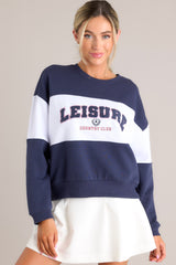 Full front view of this sweatshirt that features a ribbed crew neckline, high contrast color blocking, embroidered & terry cloth wording, ribbed cuffed sleeves, and a ribbed hemline.