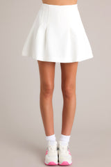 Front view of this skort that features a high waist, a zipper down the side, pleated detail, and built in shorts. 